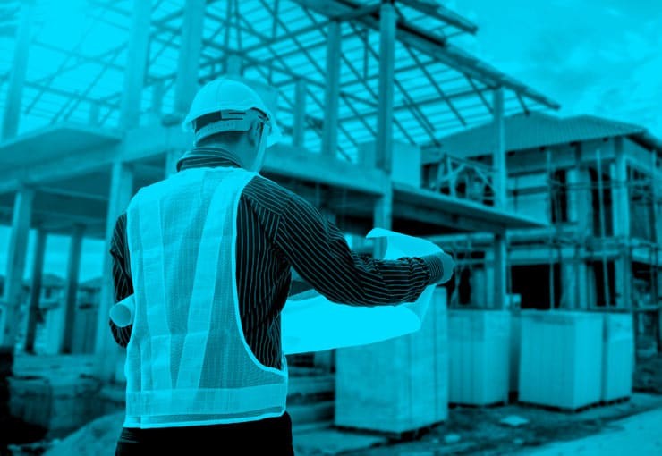 Construction worker reading plans